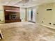 Unfinished basement with a brick fireplace, concrete floor, and glass doors at 8417 Rolling Hills Ave, Hickory, NC 28602