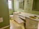 Bathroom featuring double vanity, a toilet, and a mirror at 8417 Rolling Hills Ave, Hickory, NC 28602