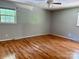 Spacious bedroom featuring hardwood floors, neutral walls, and a ceiling fan at 8417 Rolling Hills Ave, Hickory, NC 28602