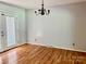 Dining room features hardwood floors, neutral walls, chandelier and a door to outside at 8417 Rolling Hills Ave, Hickory, NC 28602