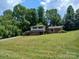 Charming two-story home with brick accents, mature trees, and a spacious front yard at 8417 Rolling Hills Ave, Hickory, NC 28602