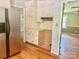 Kitchen with stainless steel refrigerator, white cabinets and wood floors at 8417 Rolling Hills Ave, Hickory, NC 28602