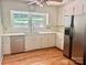 Traditional kitchen featuring white cabinets, stainless steel appliances, and hardwood floors at 8417 Rolling Hills Ave, Hickory, NC 28602