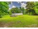 A lush green backyard featuring a pool and a mobile home at 10435 Silver Mine Rd, Fort Mill, SC 29707