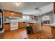 Traditional kitchen features wood cabinets, white appliances, and a central island at 10435 Silver Mine Rd, Fort Mill, SC 29707
