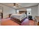 Bright main bedroom with large bed, ceiling fan, and natural light from windows at 10435 Silver Mine Rd, Fort Mill, SC 29707