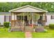 Inviting covered porch featuring a seating area and charming decorative accents at 10435 Silver Mine Rd, Fort Mill, SC 29707