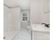 Well-lit bathroom featuring a sink with a black faucet, a shower, and marble-patterned floors at 105 Mcgill Nw Ave, Concord, NC 28025