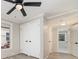 Bedroom boasts a ceiling fan, double closets, and access to an en suite bathroom, all with modern gray walls at 105 Mcgill Nw Ave, Concord, NC 28025