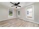 Inviting bedroom with ceiling fan, natural light from multiple windows, and modern flooring, perfect for unwinding at 105 Mcgill Nw Ave, Concord, NC 28025