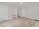 Comfortable bedroom featuring built-in shelving, multiple closets, and stylish flooring, ideal for relaxation at 105 Mcgill Nw Ave, Concord, NC 28025