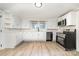 Updated kitchen with stainless steel appliances, white cabinets, and sleek countertops for a modern culinary experience at 105 Mcgill Nw Ave, Concord, NC 28025