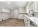 Modern kitchen featuring white cabinets, stainless steel sink with stylish faucet, and durable countertops at 105 Mcgill Nw Ave, Concord, NC 28025