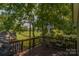 Spacious back deck with an umbrella table, chairs, and grill, overlooking a green yard at 1239 Mac Ln, Stanley, NC 28164