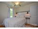 Cozy bedroom featuring a plush bed, decorative lighting, and shiplap accent wall at 1239 Mac Ln, Stanley, NC 28164