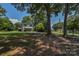 Charming two-story home with a lovely lawn and gravel driveway, framed by mature shade trees at 1239 Mac Ln, Stanley, NC 28164