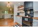 Stylish kitchen with butcher block countertops, modern appliances, and convenient open shelving at 1239 Mac Ln, Stanley, NC 28164