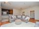 Open-concept living room, features a sectional sofa and flows into the kitchen at 1239 Mac Ln, Stanley, NC 28164