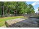 Angle view of the wooden back deck showing the wooded backyard, and fence at 1312 Shenandoah Cir, Rock Hill, SC 29730