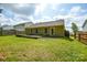 View of backyard showing the lawn, back of house, and wooden deck with space for outdoor seating at 1312 Shenandoah Cir, Rock Hill, SC 29730