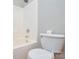 Bright bathroom featuring a tub-shower combination with white tile and a matching toilet at 1312 Shenandoah Cir, Rock Hill, SC 29730
