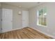 Cozy bedroom featuring wood-look flooring, neutral walls, and a window providing natural light at 1312 Shenandoah Cir, Rock Hill, SC 29730
