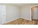Cozy bedroom featuring wood-look flooring, neutral walls, and white trim and doors at 1312 Shenandoah Cir, Rock Hill, SC 29730