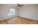 A bright bedroom boasts hardwood floors, a ceiling fan, recessed lighting, and a large window at 1312 Shenandoah Cir, Rock Hill, SC 29730