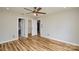 Bedroom with hardwood floors, an open closet and bathroom doorway, and neutral wall colors at 1312 Shenandoah Cir, Rock Hill, SC 29730