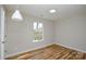 Bright bedroom featuring modern flooring, white trim, and a window providing natural light at 1312 Shenandoah Cir, Rock Hill, SC 29730