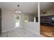 Bright dining area with modern light fixture, gray wood-look flooring, and natural light at 1312 Shenandoah Cir, Rock Hill, SC 29730