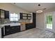 Modern kitchen featuring stainless steel appliances, farmhouse sink, and stylish black cabinets at 1312 Shenandoah Cir, Rock Hill, SC 29730
