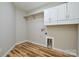 Laundry room with white cabinets and a utility sink, wood flooring and neutral paint at 1312 Shenandoah Cir, Rock Hill, SC 29730