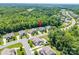 Aerial view of a neighborhood featuring well-manicured lawns and tree-lined streets with large, established trees at 1320 Torrens Dr, Wesley Chapel, NC 28110