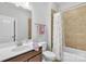 Bright bathroom featuring a vanity with sink, toilet, decorative towels and bathtub with shower and white curtain at 1320 Torrens Dr, Wesley Chapel, NC 28110