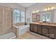 Bright bathroom with a glass enclosed shower, soaking tub and double sink vanity at 1320 Torrens Dr, Wesley Chapel, NC 28110