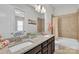 Double sink vanity has a granite counter in a bathroom that has a tub and shower at 1320 Torrens Dr, Wesley Chapel, NC 28110