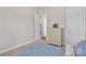 Comfortable bedroom with coordinated decor and a view to another room through an open doorway at 1320 Torrens Dr, Wesley Chapel, NC 28110
