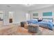Spacious bedroom features two beds and a stylish rug with a view to the en suite bath at 1320 Torrens Dr, Wesley Chapel, NC 28110