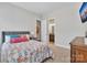 Comfortable bedroom with coordinated decor and a view to the en suite bathroom through an open doorway at 1320 Torrens Dr, Wesley Chapel, NC 28110