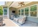 Covered deck featuring wicker furniture, ceiling fan and outdoor lighting with a view of backyard at 1320 Torrens Dr, Wesley Chapel, NC 28110
