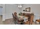 Elegant dining room featuring a classic wooden table and chairs, and a decorative chandelier at 1320 Torrens Dr, Wesley Chapel, NC 28110