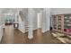Elegant foyer with hardwood floors, white trim, staircase, and stylish decor at 1320 Torrens Dr, Wesley Chapel, NC 28110