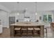 Spacious kitchen island with granite countertop, stainless steel appliances, and pendant lighting at 1320 Torrens Dr, Wesley Chapel, NC 28110