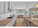 Open kitchen with granite countertops, stainless appliances, and dining area beyond at 1320 Torrens Dr, Wesley Chapel, NC 28110