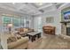 Inviting living room featuring a stone fireplace, coffered ceiling and lots of natural light at 1320 Torrens Dr, Wesley Chapel, NC 28110