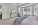 Relaxing primary bedroom with sitting area, dresser and lots of natural light at 1320 Torrens Dr, Wesley Chapel, NC 28110