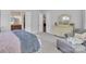 Bright main bedroom features a relaxing chaise lounge and a painted dresser with large mirror at 1320 Torrens Dr, Wesley Chapel, NC 28110