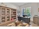 Stylish home office featuring built-in shelving, a large window, and a comfortable workspace at 1320 Torrens Dr, Wesley Chapel, NC 28110