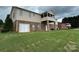 Spacious backyard featuring a patio, screened porch, and a well-maintained lawn on the basement-level home at 1519 Midland Dr, Hudson, NC 28658